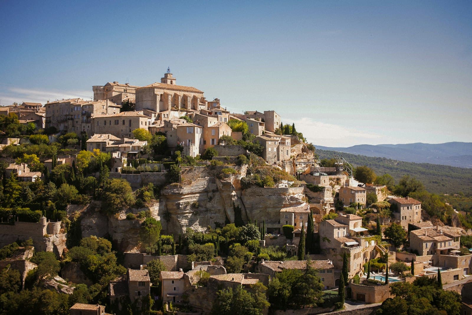 Avignon — a village on top of a hill surrounded by trees