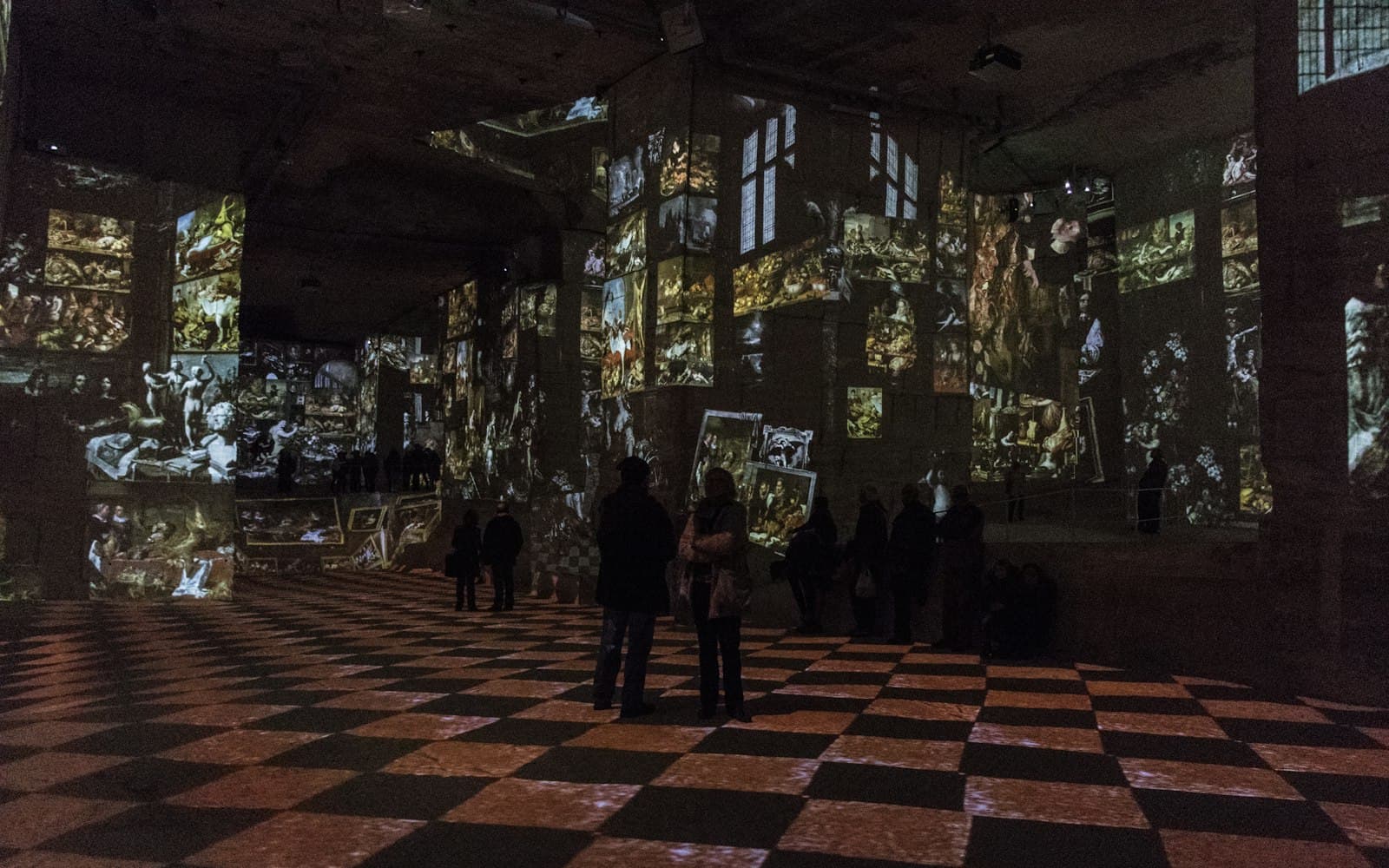 Les Baux-de-Provence — a group of people standing in a room with a checkered floor
